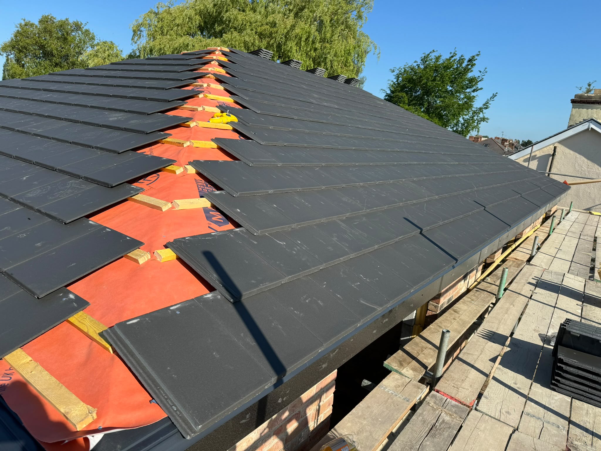 Completed charcoal tiled hip roof by Roofing North East