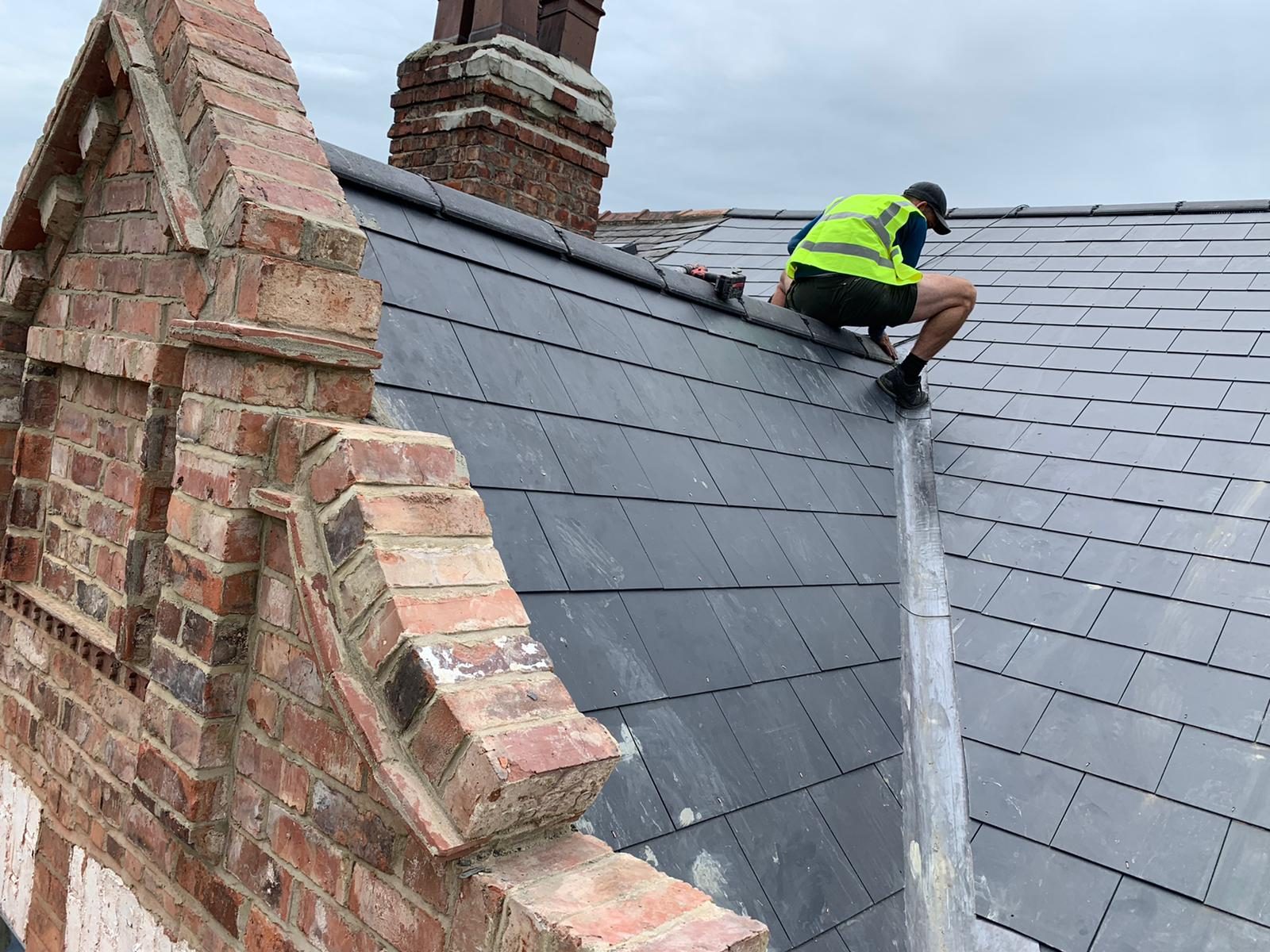 A traditional slate mansard roof on a grand period property